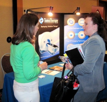 Rita Gable, TomoTherapy, with meeting attendee